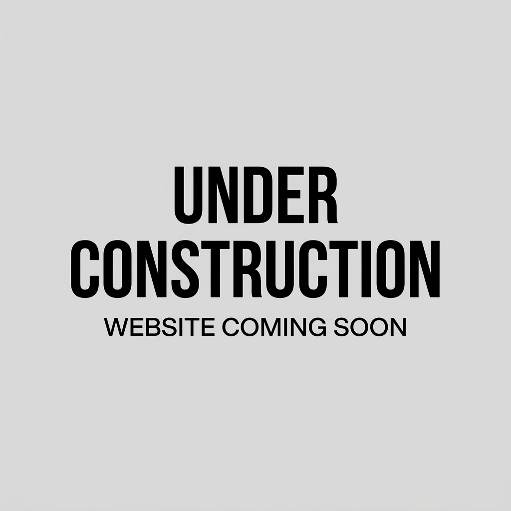 Two people working on laptops next to a website under construction sign and traffic cones on city sidewalk